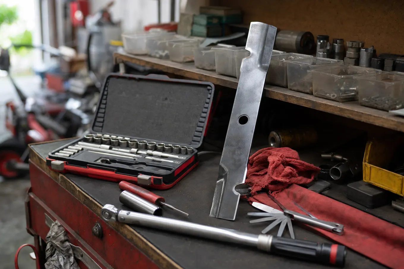 Organized lawn mower repair workbench with tools at the Port Charlotte shop