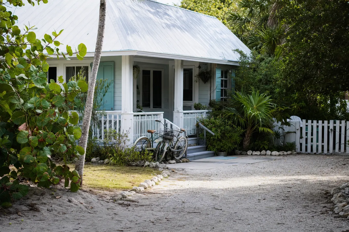 Coastal Florida cottage yard with sea grapes and a small sandy lawn
