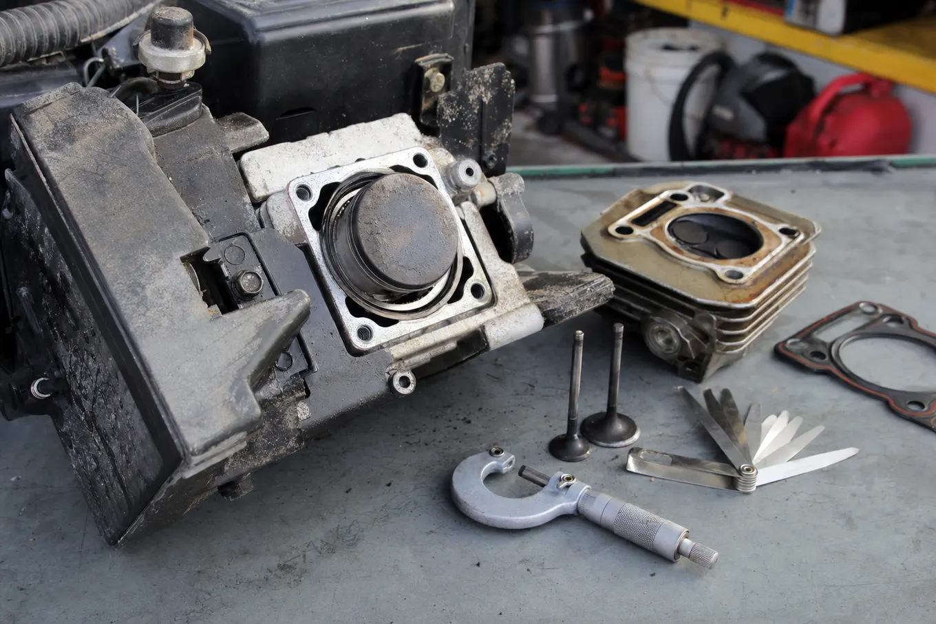 Small gas engine partially disassembled for repair on a clean bench